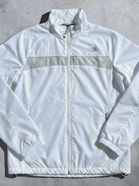 The Hydrenalite North Face White Jacket with Gray Reflective Logo. Women’s large